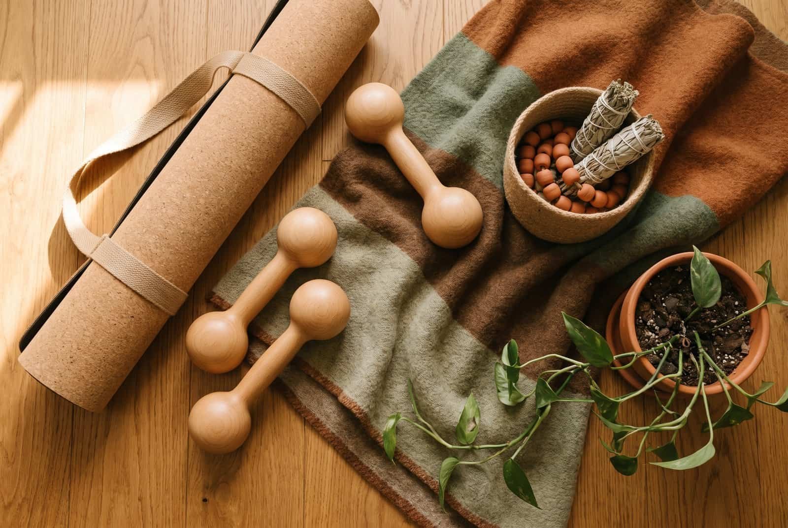 Craftsman home gym design flat lay with a cork mat and beechwood dumbbells